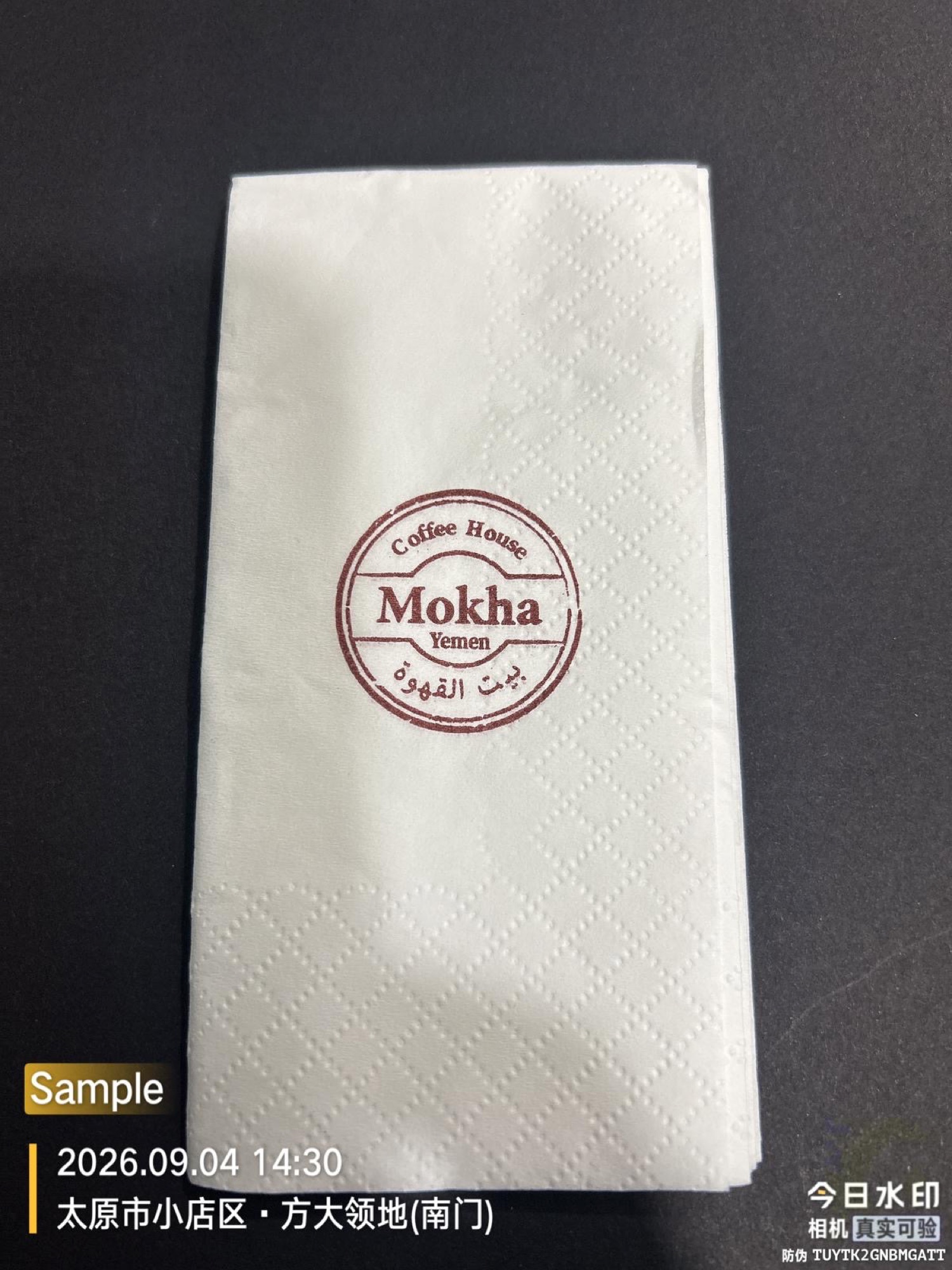 White Mokha Coffee House branded two-ply dinner napkin folded to one-eighth size